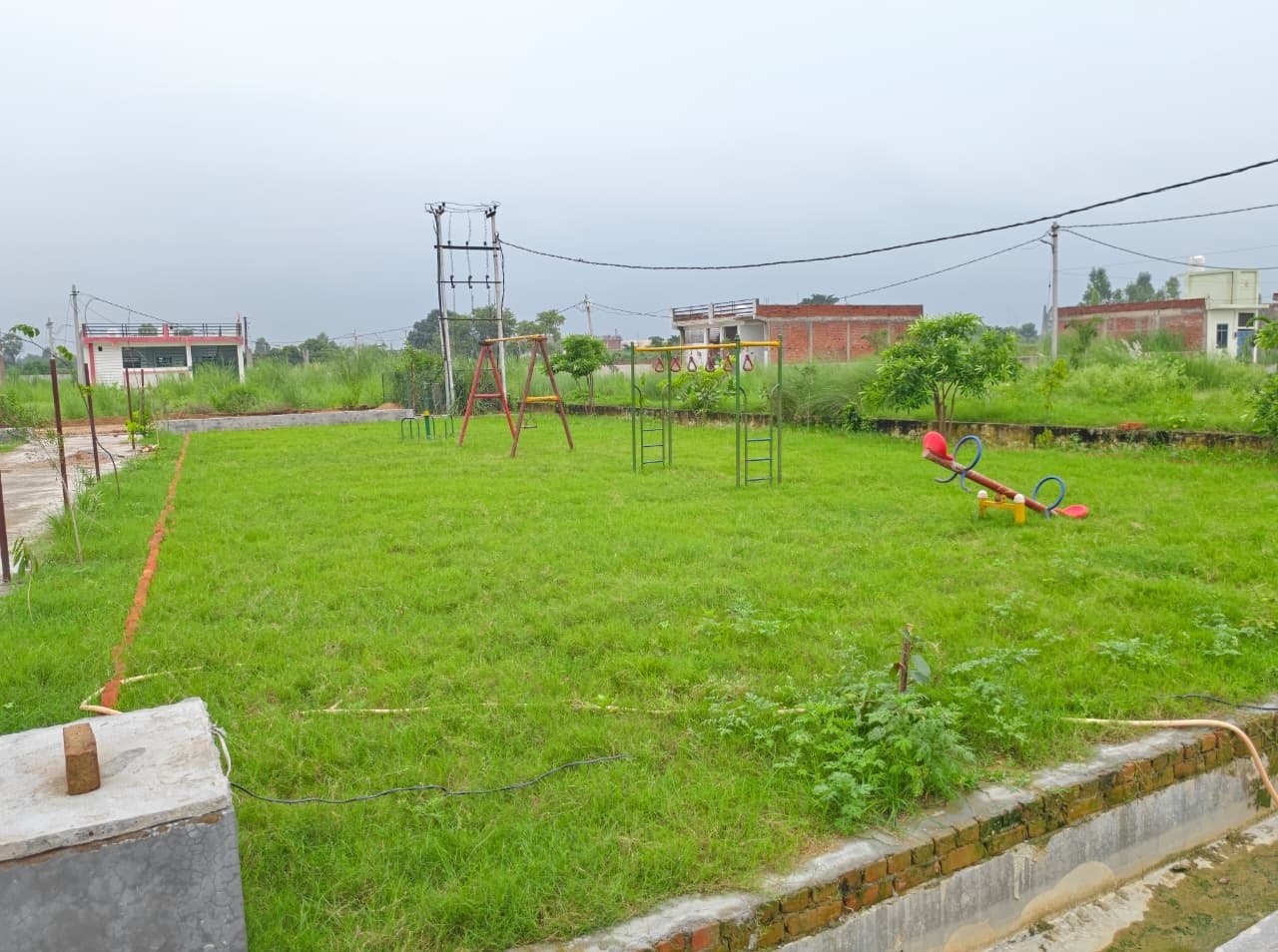 Dauwa Green City children park with lush green grass and swings